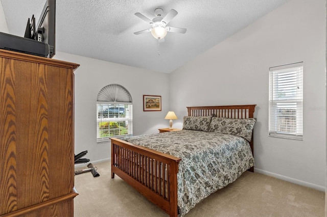 bedroom with light carpet, a textured ceiling, lofted ceiling, baseboards, and ceiling fan
