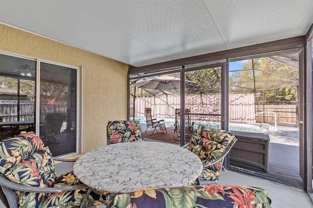 sunroom / solarium with outdoor dining area