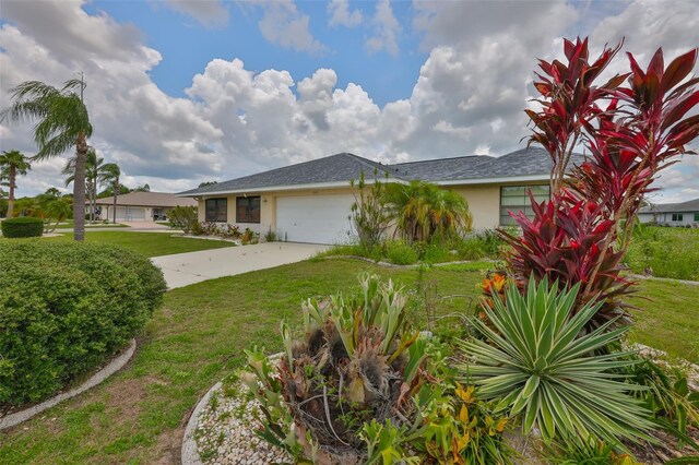 1915 W Del Webb Blvd, Sun City Center, FL 33573 - view of front of home featuring a garage, stucco siding, a front lawn, and driveway