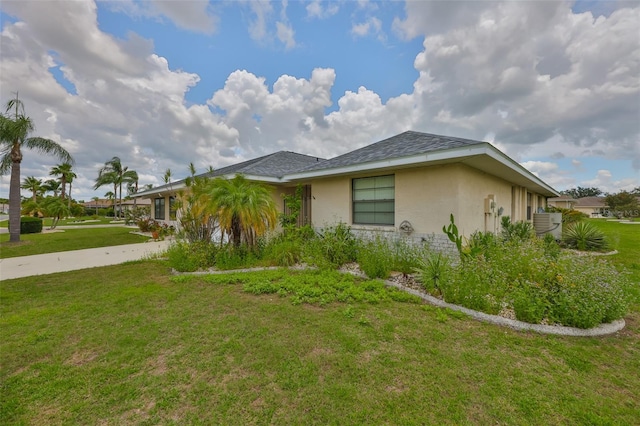 1915 W Del Webb Blvd, Sun City Center, FL 33573 - view of side of home with stucco siding and a lawn