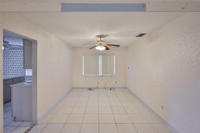 1915 W Del Webb Blvd, Sun City Center, FL 33573 - spare room with a ceiling fan, light tile patterned floors, a textured ceiling, and baseboards