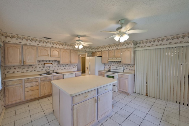 1915 W Del Webb Blvd, Sun City Center, FL 33573 - kitchen featuring white appliances, a sink, light countertops, wallpapered walls, and a ceiling fan