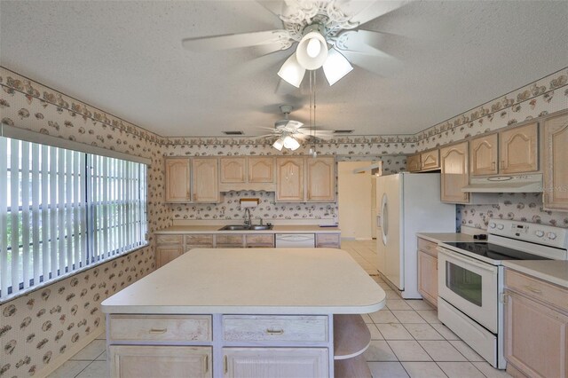 1915 W Del Webb Blvd, Sun City Center, FL 33573 - kitchen featuring white appliances, under cabinet range hood, wallpapered walls, a kitchen island, and light countertops