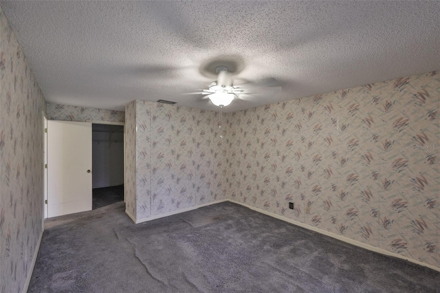 1915 W Del Webb Blvd, Sun City Center, FL 33573 - spare room with ceiling fan, dark carpet, wallpapered walls, a textured ceiling, and baseboards