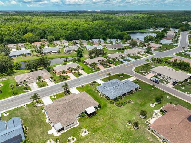 1915 W Del Webb Blvd, Sun City Center, FL 33573 - aerial view of property and surrounding area with a forest, a nearby body of water, and nearby suburban area