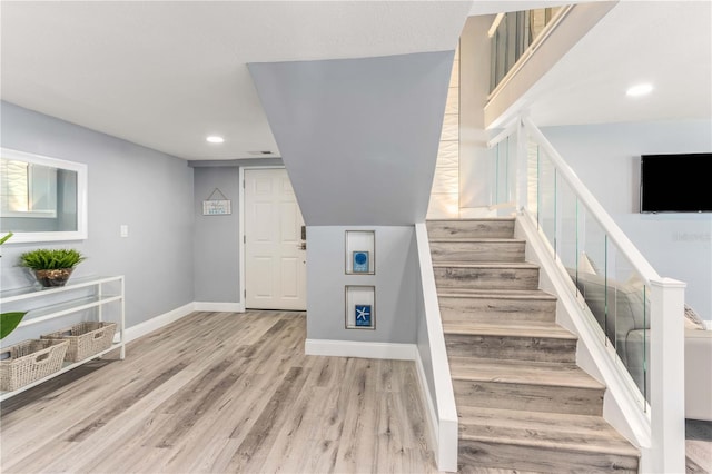 1390 Gulf Blvd Unit Ph-5, Clearwater, FL 33767 - stairway featuring wood finished floors, baseboards, and recessed lighting