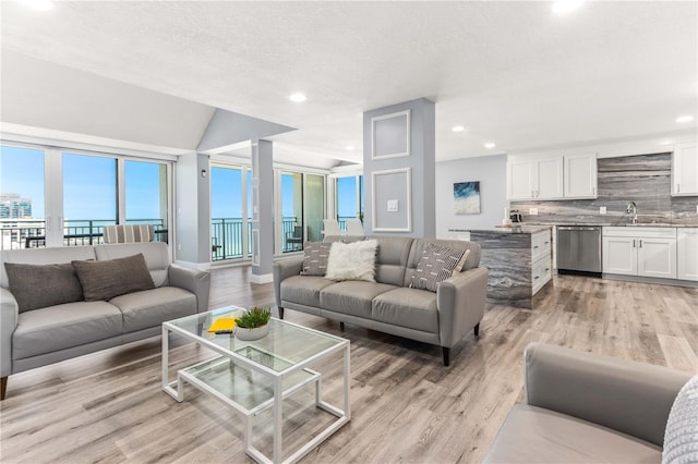 1390 Gulf Blvd Unit Ph-5, Clearwater, FL 33767 - living room featuring light wood-style floors, recessed lighting, and baseboards