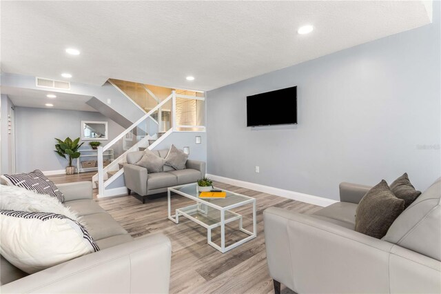 1390 Gulf Blvd Unit Ph-5, Clearwater, FL 33767 - living room with stairs, wood finished floors, baseboards, and recessed lighting