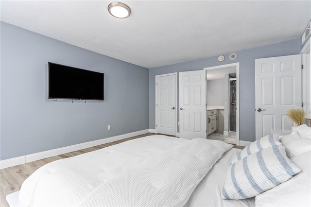 1390 Gulf Blvd Unit Ph-5, Clearwater, FL 33767 - bedroom with baseboards, a closet, and light wood-style floors