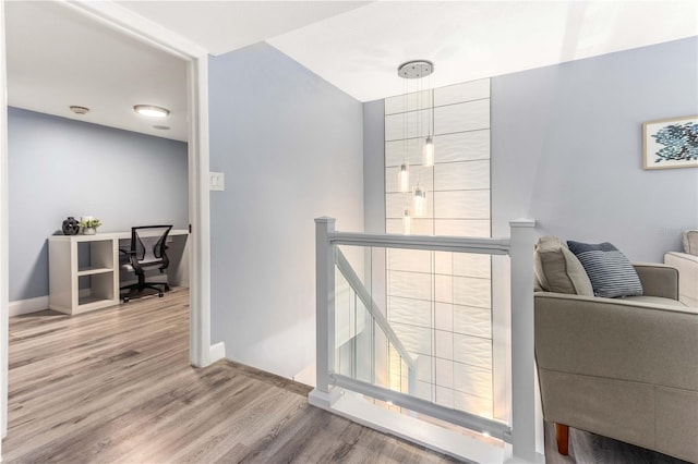 1390 Gulf Blvd Unit Ph-5, Clearwater, FL 33767 - hallway featuring an upstairs landing, wood finished floors, baseboards, and an office area