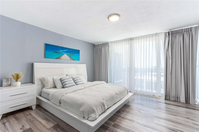 1390 Gulf Blvd Unit Ph-5, Clearwater, FL 33767 - bedroom with wood finished floors