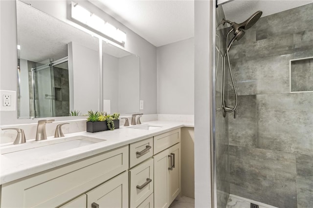 1390 Gulf Blvd Unit Ph-5, Clearwater, FL 33767 - bathroom with marble look tiles, a shower stall, double vanity, and a textured ceiling