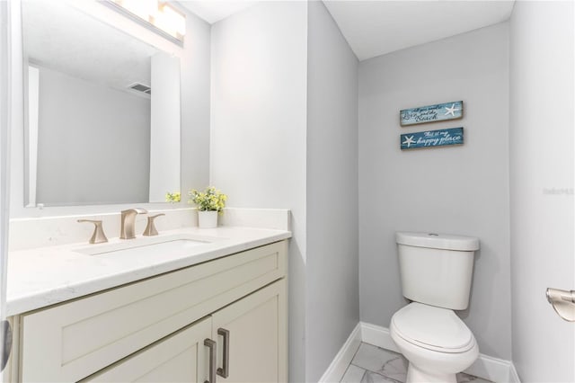 1390 Gulf Blvd Unit Ph-5, Clearwater, FL 33767 - half bathroom with marble finish flooring, baseboards, toilet, and vanity