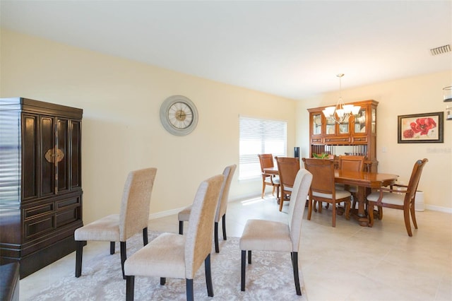dining space with an inviting chandelier, baseboards, light tile patterned floors, and visible vents