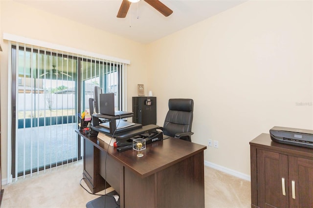 office with ceiling fan, light colored carpet, and baseboards