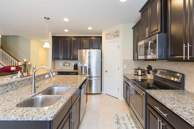kitchen featuring dark brown cabinetry, light tile patterned flooring, recessed lighting, a sink, and appliances with stainless steel finishes