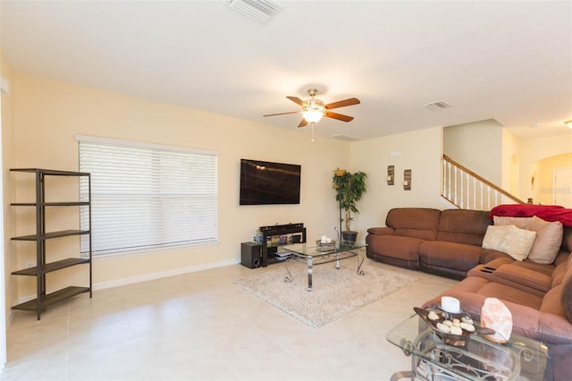 living area featuring visible vents, a ceiling fan, light tile patterned floors, and stairway