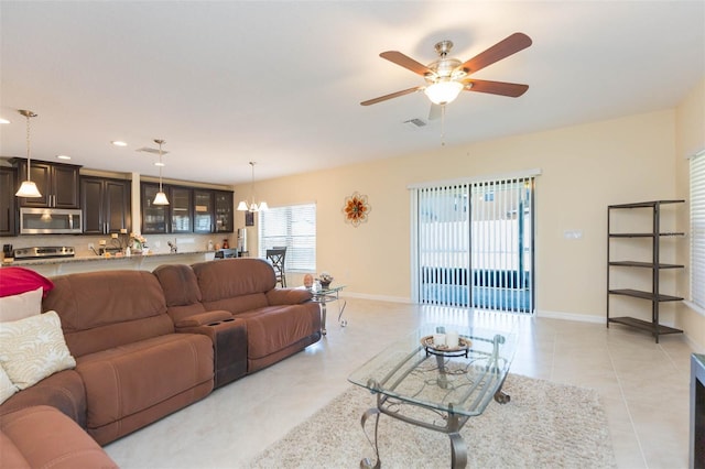 living room featuring a ceiling fan, visible vents, baseboards, recessed lighting, and light tile patterned flooring
