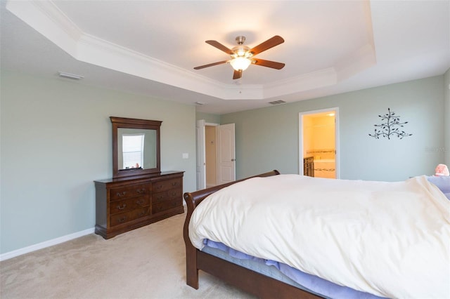 bedroom featuring crown molding, a tray ceiling, visible vents, and light carpet