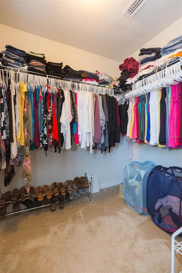 spacious closet with carpet flooring and visible vents