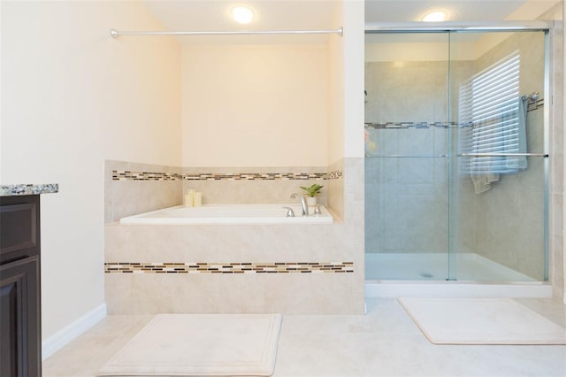 full bathroom featuring vanity, tile patterned floors, a shower stall, and a garden tub