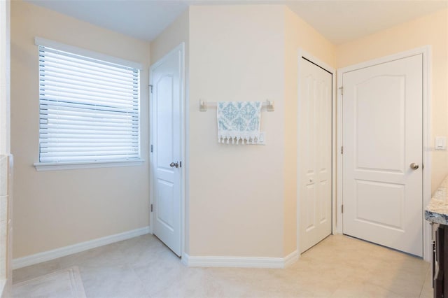 corridor with baseboards and plenty of natural light