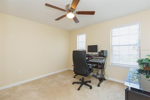 office featuring ceiling fan, light colored carpet, and baseboards