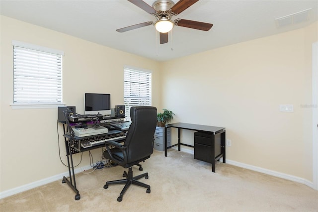 office with visible vents, a ceiling fan, carpet, and baseboards