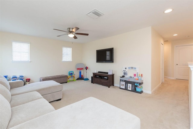 living room featuring visible vents, baseboards, recessed lighting, light colored carpet, and a ceiling fan