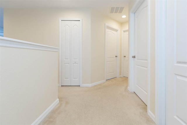 hallway featuring light colored carpet, recessed lighting, baseboards, and visible vents