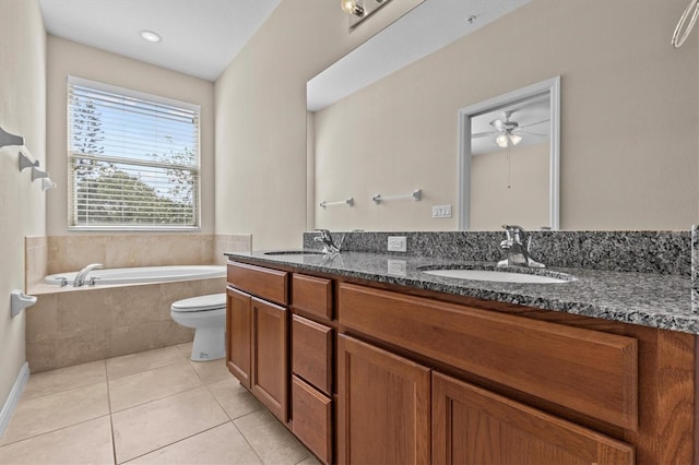bathroom featuring tile patterned flooring, a bath, double vanity, ceiling fan, and toilet