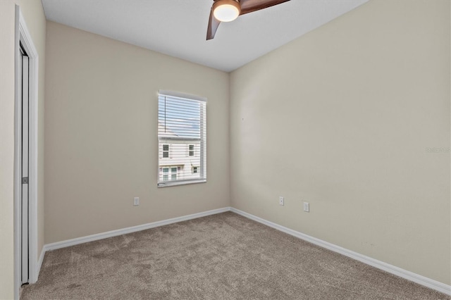 unfurnished bedroom with carpet flooring, baseboards, ceiling fan, and a closet