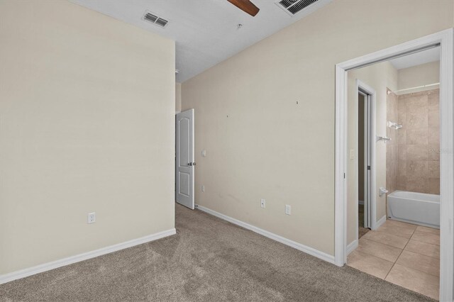 empty room with light carpet, a ceiling fan, and baseboards