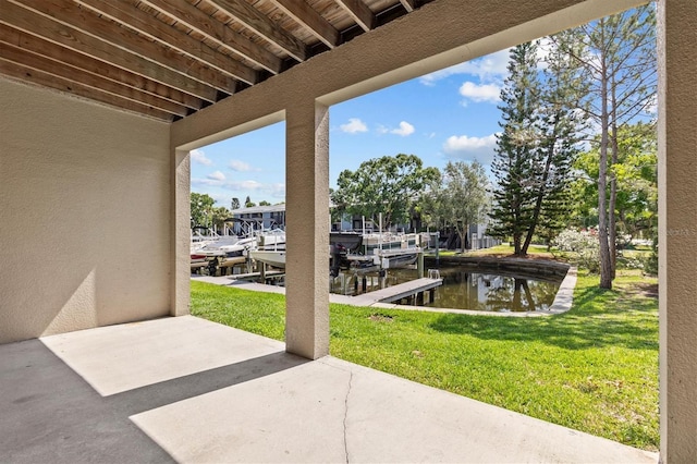 view of patio with boat lift, a water view, and a boat dock