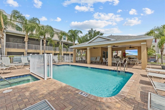 community pool with fence, a patio, and ceiling fan