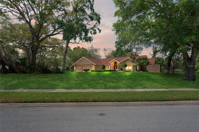 7353 Dogwood Cres, Spring Hill, FL 34607 - ranch-style home featuring an attached garage and a lawn