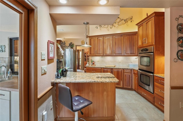 7353 Dogwood Cres, Spring Hill, FL 34607 - kitchen with stainless steel appliances, brown cabinetry, a sink, and a peninsula