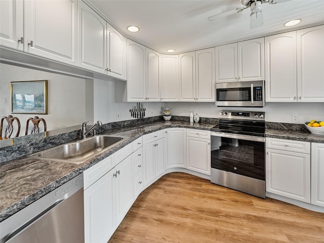 kitchen featuring a ceiling fan, appliances with stainless steel finishes, a sink, white cabinets, and recessed lighting