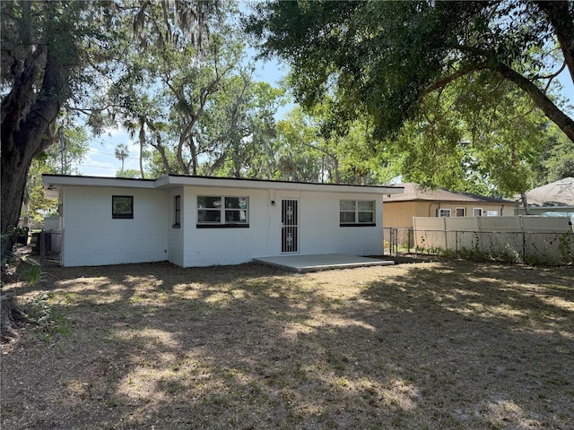 635 Mccormick St, Daytona Beach, FL 32114 - rear view of house with a patio and fence