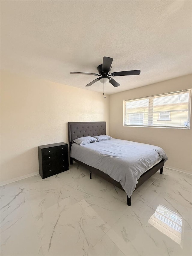 635 Mccormick St, Daytona Beach, FL 32114 - bedroom with baseboards, marble finish floor, and a textured ceiling
