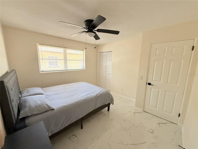 635 Mccormick St, Daytona Beach, FL 32114 - bedroom with a closet, marble finish floor, ceiling fan, and baseboards