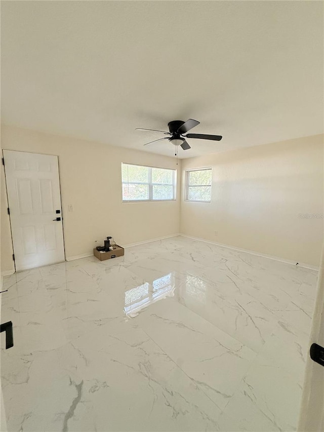 635 Mccormick St, Daytona Beach, FL 32114 - empty room featuring baseboards, a ceiling fan, and marble finish floor