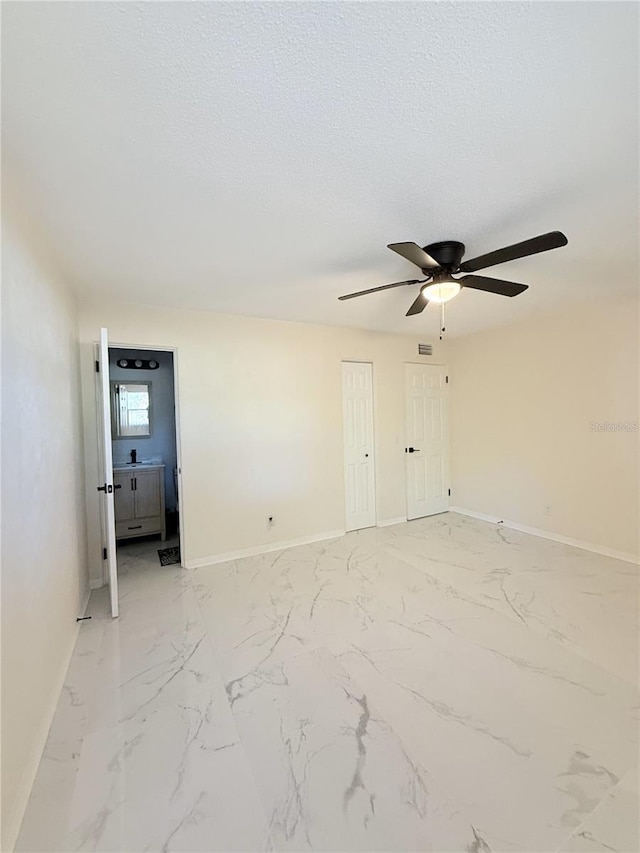 635 Mccormick St, Daytona Beach, FL 32114 - spare room with a ceiling fan, baseboards, and marble finish floor