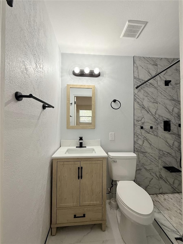 635 Mccormick St, Daytona Beach, FL 32114 - full bathroom with vanity, toilet, marble finish floor, visible vents, and tiled shower