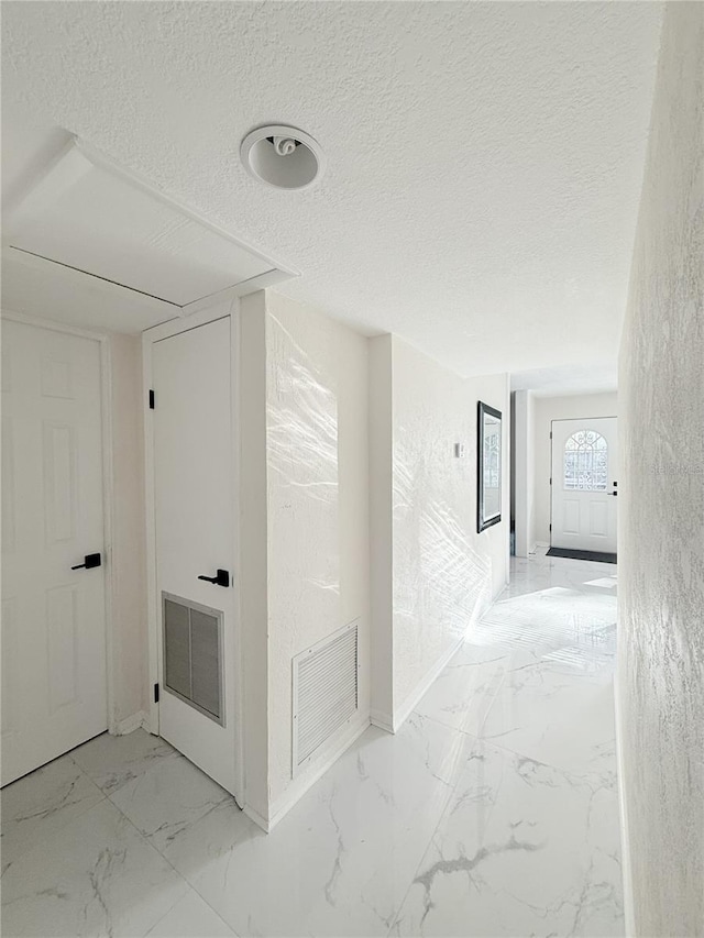 635 Mccormick St, Daytona Beach, FL 32114 - hall with a textured ceiling, baseboards, visible vents, and marble finish floor