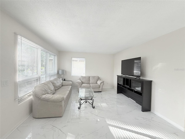 635 Mccormick St, Daytona Beach, FL 32114 - living area featuring a textured ceiling, baseboards, and marble finish floor