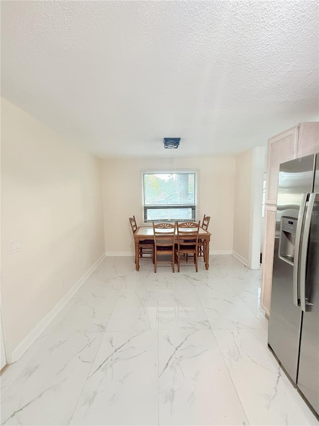 635 Mccormick St, Daytona Beach, FL 32114 - dining room with baseboards, a textured ceiling, and marble finish floor