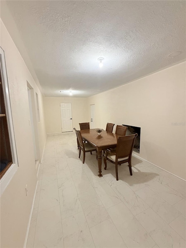 635 Mccormick St, Daytona Beach, FL 32114 - dining room with baseboards, a textured ceiling, and marble finish floor