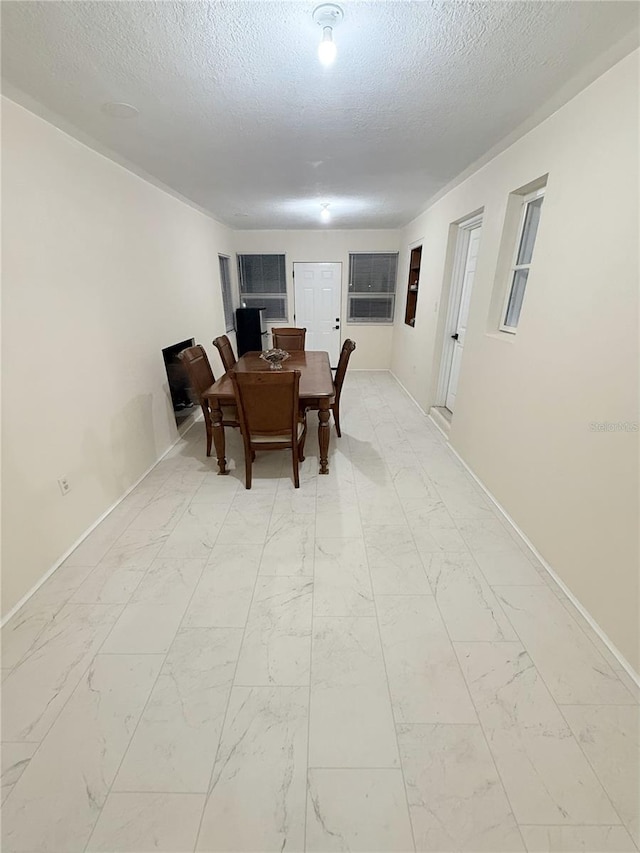 635 Mccormick St, Daytona Beach, FL 32114 - dining space with a textured ceiling, baseboards, and marble finish floor