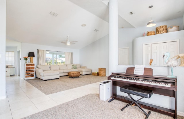 tiled living area with carpet, vaulted ceiling, a ceiling fan, and ornate columns